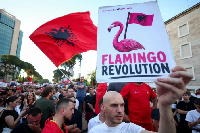 A demonstrator holds a placard during a protest against a luxury resort, a plan by a company linked to U.S. President Donald Trump's son-in-law, Jared Kushner, on an environmentally sensitive part of the Adriatic coast, in Tirana, Albania, June 8, 2026. REUTERS/Florion Goga