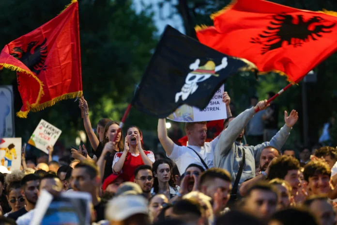Protesters wave Albanian national flags during a protest against a luxury resort development planned by a company linked with Donald Trump's son-in-law, Jared Kushner, on an environmentally sensitive part of the Adriatic coast, in Tirana, Albania, June 4, 2026. REUTERS/Florion Goga